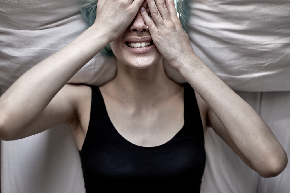 Woman lying in bed depressed and upset