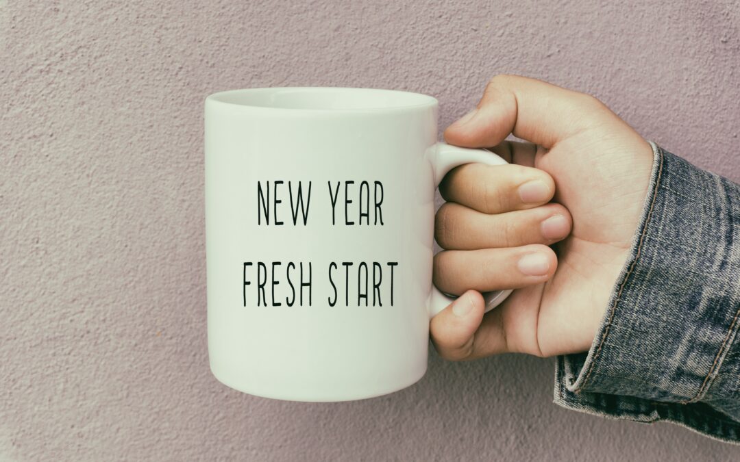 image of person holding coffee cup with "New Year. Fresh Start"
