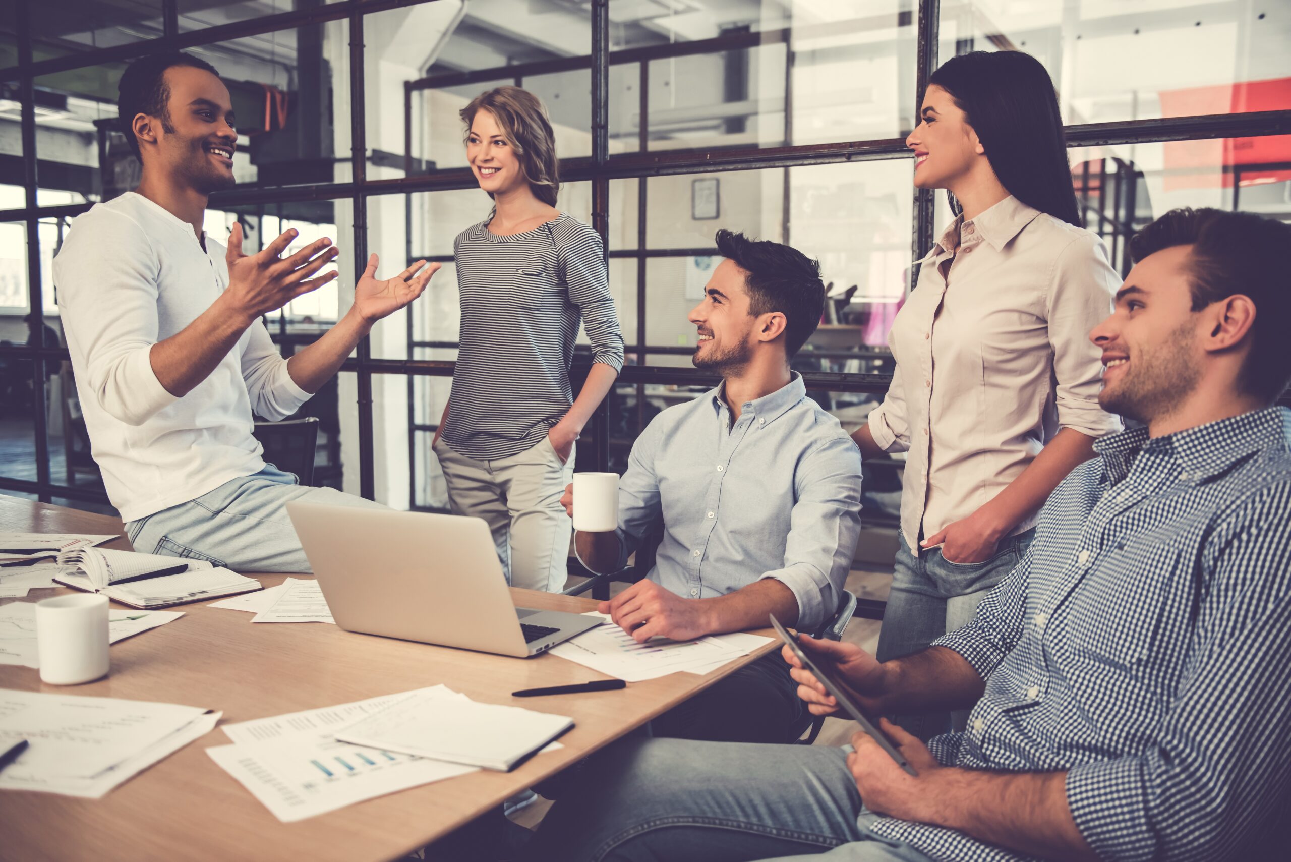 Employees talking around a desk