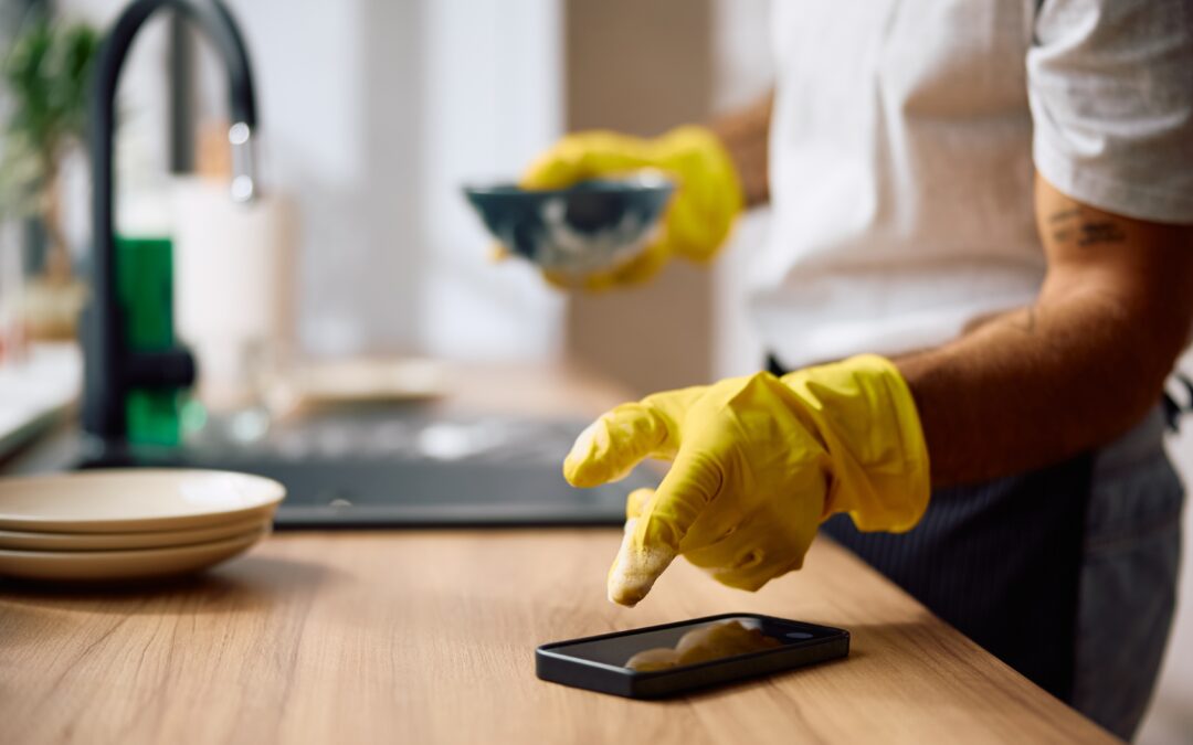 man doing dishes while taking a call